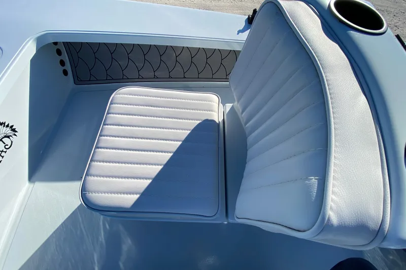 Slide: The Image of 2024 Drake Boatworks Nomad interior with white cushioned seating and stylish design. - 32