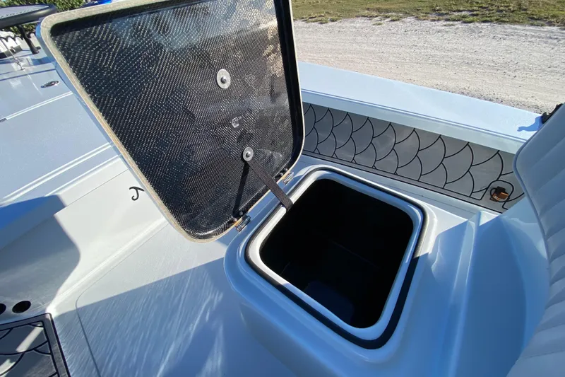 Slide: The Image of 2024 Drake Boatworks Nomad storage compartment with open hatch, showcasing interior design. - 33