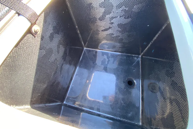 Slide: The Image of 2024 Drake Boatworks Nomad storage compartment with drain hole, featuring a sleek, durable design. - 34