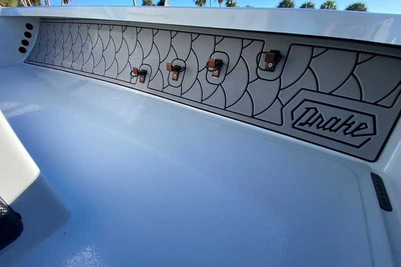 Slide: The Image of 2024 Drake Boatworks Nomad interior with stylish paneling and logo detail. - 35