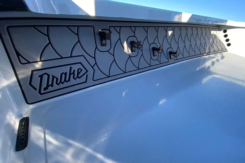 Slide: The Image of 2024 Drake Boatworks Nomad interior with custom panel design and logo detailing. - 36