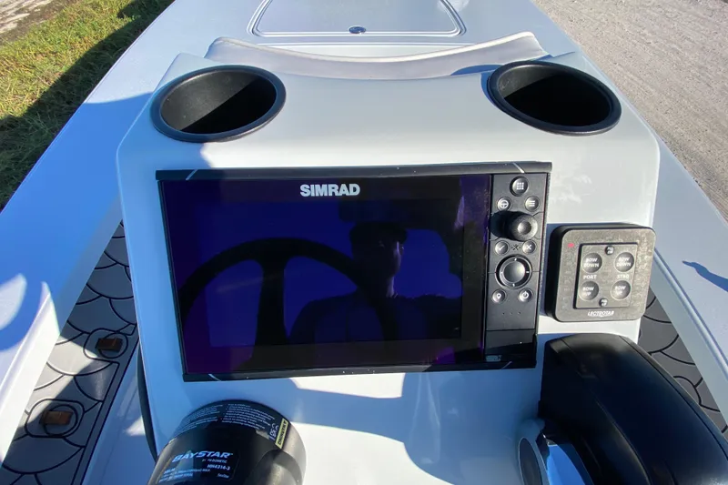 Slide: The Image of 2024 Drake Boatworks Nomad dashboard with Simrad display and controls. - 39