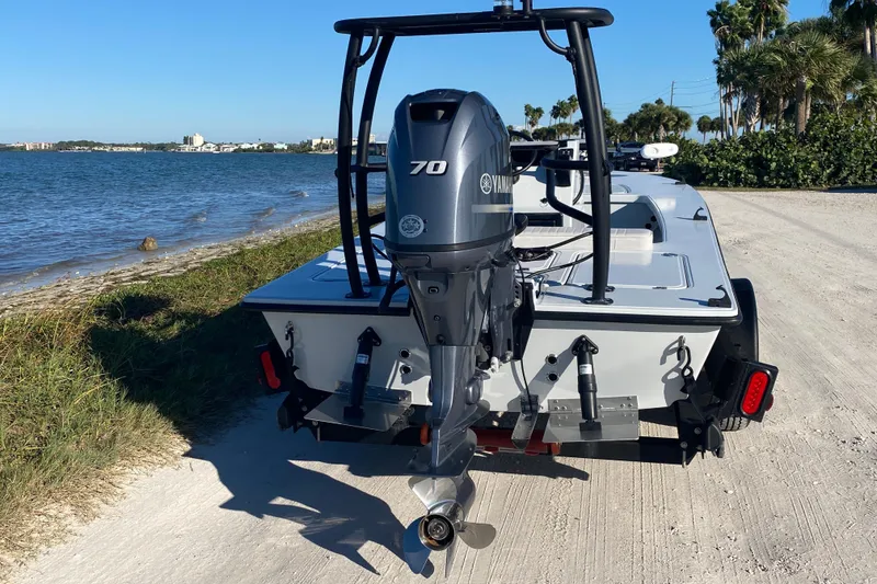 Slide: The Image of 2024 Drake Boatworks Nomad with Yamaha 70 engine by the shoreline. - 4