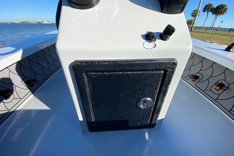 Slide: The Image of 2024 Drake Boatworks Nomad console with storage compartment, ocean view, and decorative interior design. - 40