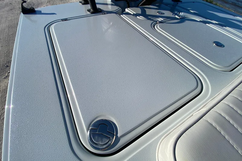 Slide: The Image of 2024 Drake Boatworks Nomad deck with sleek, textured surface and secure hatch. - 48