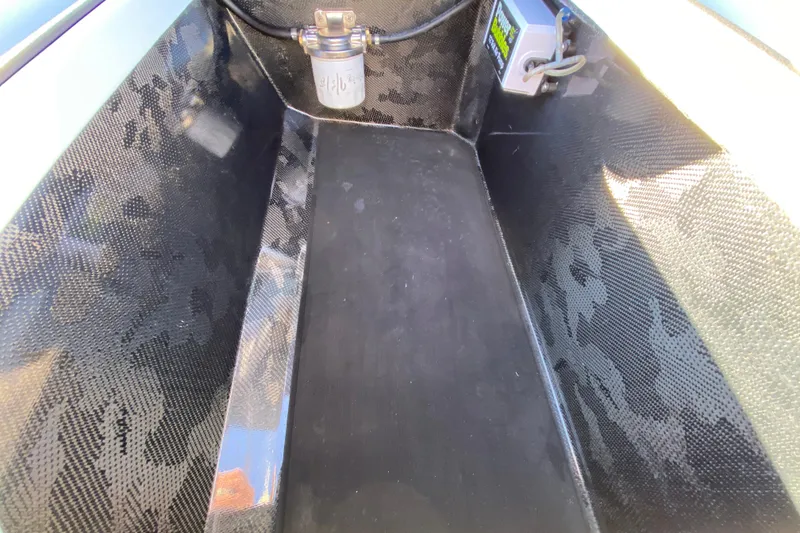 Slide: The Image of 2024 Drake Boatworks Nomad interior with carbon fiber finish and electrical components. - 51