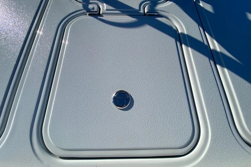 Slide: The Image of 2024 Drake Boatworks Nomad deck hatch with textured surface and metal handle. - 52