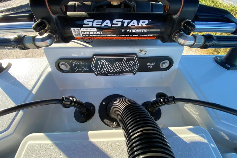 Slide: The Image of 2024 Drake Boatworks Nomad dashboard with SeaStar steering system. - 61