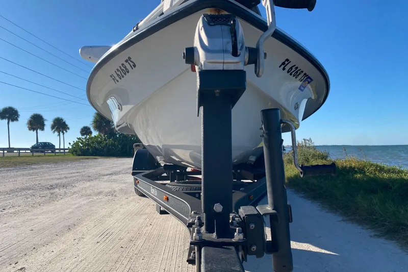 Slide: The Image of 2024 Drake Boatworks Nomad on trailer by scenic waterfront road. - 8