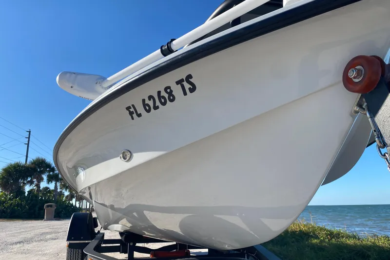 Slide: The Image of 2024 Drake Boatworks Nomad on trailer by the sea, under clear blue sky. - 9