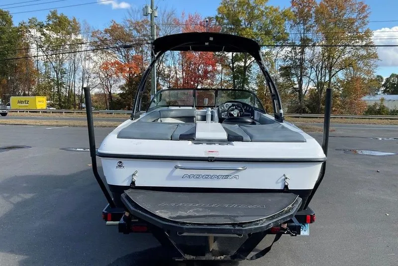 Slide: The Image of 2015 Moomba Outback V boat, rear view, parked outdoors with autumn trees in background. - 13