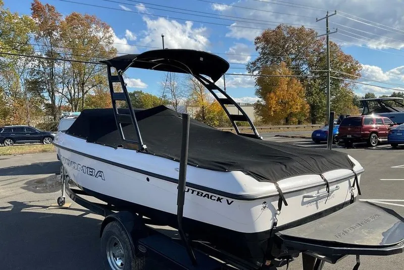 Slide: The Image of 2015 Moomba Outback V boat with cover on trailer, parked outdoors. - 14
