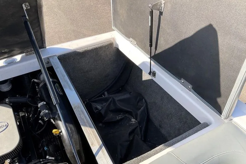 Slide: The Image of 2015 Moomba Outback V engine compartment with open storage area and hydraulic lift supports. - 16