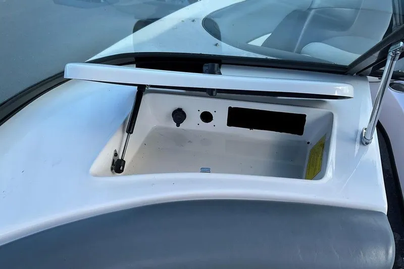 Slide: The Image of 2015 Moomba Outback V boat storage compartment with open lid and hydraulic support. - 3