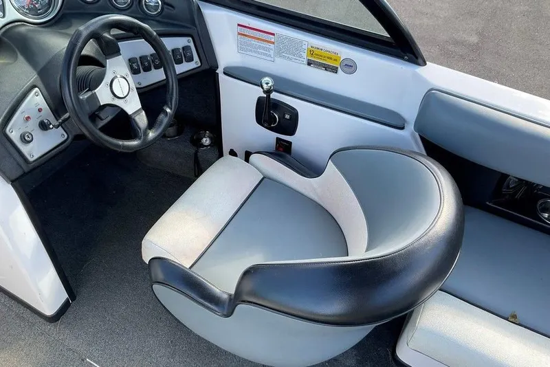 Slide: The Image of 2015 Moomba Outback V boat interior with steering wheel and captain's chair. - 4