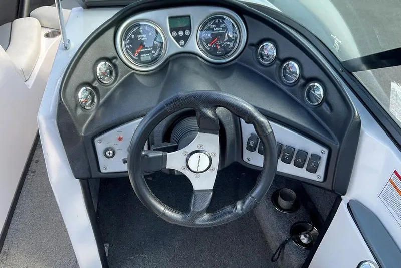 Slide: The Image of 2015 Moomba Outback V dashboard with steering wheel and gauges. - 6