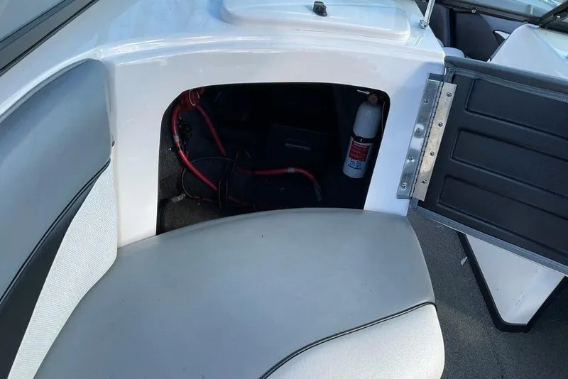 Slide: The Image of 2015 Moomba Outback V boat interior storage compartment with fire extinguisher and wiring. - 7