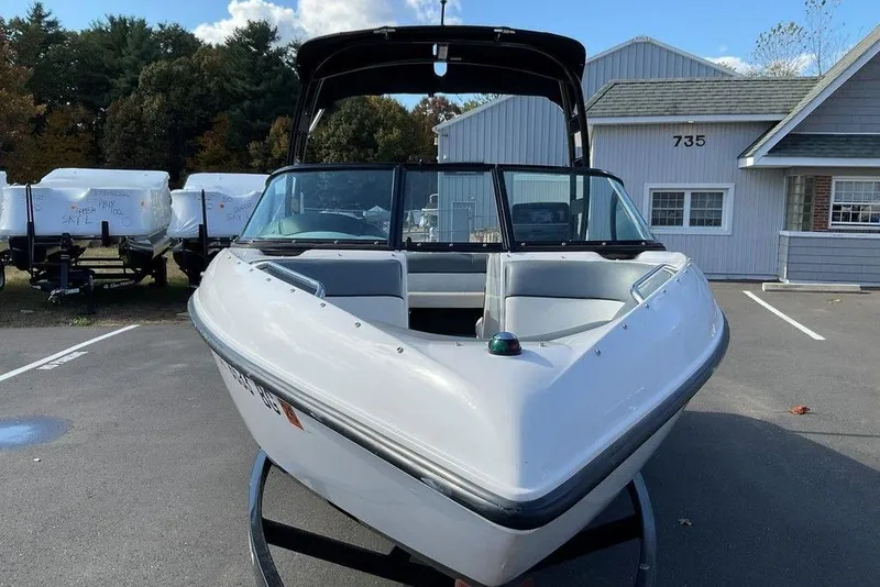 Slide: The Image of 2015 Moomba Outback V boat parked in a lot, front view. - 9