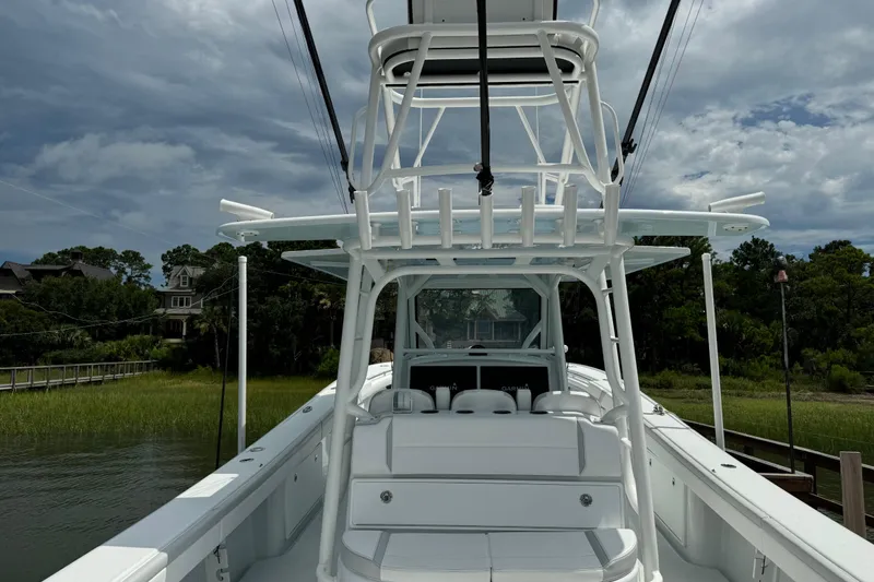 Slide: The Image of 2024 Yellowfin 39 Offshore boat docked, showcasing sleek design and spacious deck. - 16