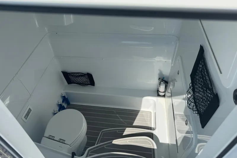 Slide: The Image of 2024 Yellowfin 39 Offshore boat interior with toilet and storage nets. - 23
