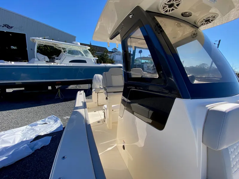 Slide: The Image of 2026 Scout 260 LXF boat with sleek design and modern features, docked outdoors. - 14