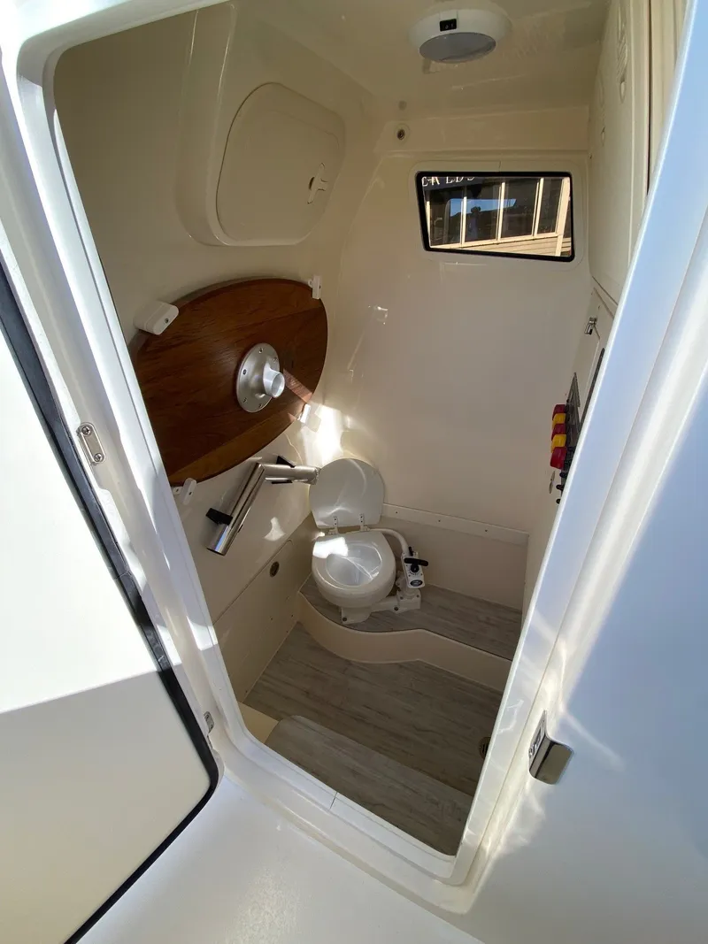 Slide: The Image of 2026 Scout 260 LXF boat interior bathroom with modern amenities and compact design. - 16