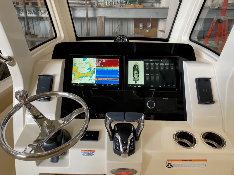 Slide: The Image of 2026 Scout 260 LXF boat with Yamaha engine at marina under clear blue sky. - 4