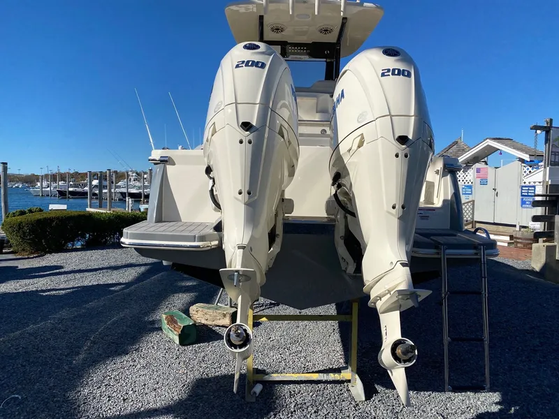 Slide: The Image of 2026 Scout 260 LXF boat with twin 200 horsepower engines, docked by the marina. - 5