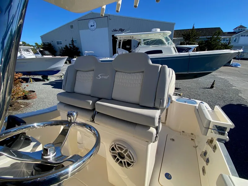 Slide: The Image of 2026 Scout 260 LXF boat interior with steering wheel and cushioned seating. - 9