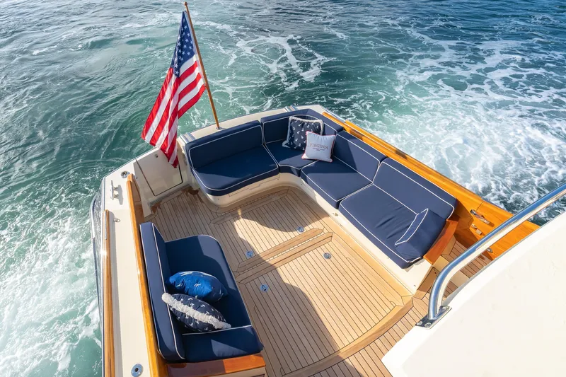 Slide: The Image of Hinckley Talaria 48 Flybridge 2013 yacht with elegant deck seating and American flag. - 10