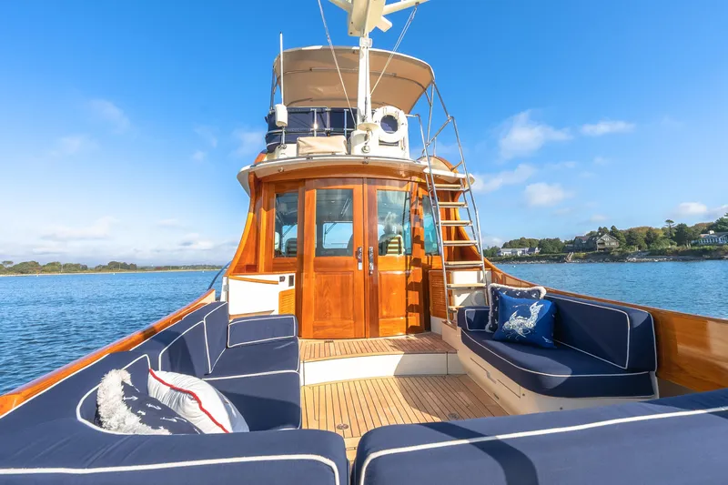 Slide: The Image of 2013 Hinckley Talaria 48 Flybridge yacht with elegant seating and scenic water view. - 14