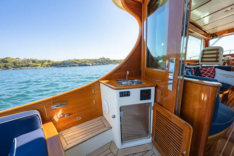 Slide: The Image of Luxurious 2013 Hinckley Talaria 48 Flybridge yacht interior with wooden finish and ocean view. - 16