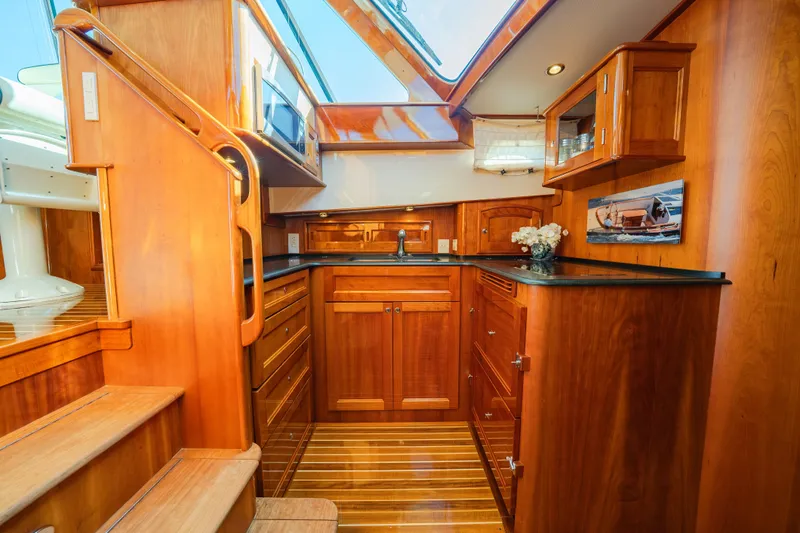 Slide: The Image of Luxurious wooden interior of 2013 Hinckley Talaria 48 Flybridge yacht kitchen. - 25