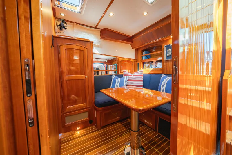 Slide: The Image of Luxurious interior of 2013 Hinckley Talaria 48 Flybridge with polished wood and cozy seating. - 30