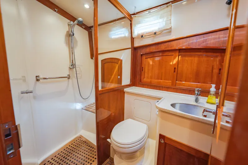Slide: The Image of Luxurious bathroom in 2013 Hinckley Talaria 48 Flybridge yacht with wood accents and modern fixtures. - 33