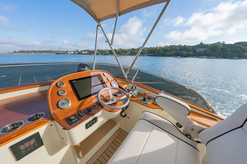 Slide: The Image of Helm of 2013 Hinckley Talaria 48 Flybridge yacht with scenic water view. - 5