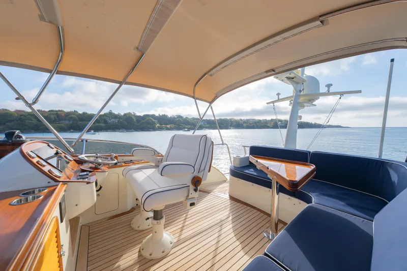 Slide: The Image of 2013 Hinckley Talaria 48 Flybridge yacht interior with elegant seating and scenic ocean view. - 7