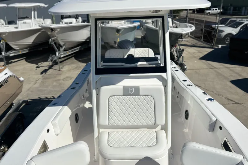 Slide: The Image of 2026 Sea Fox 228 Commander boat interior with white seating and console. - 13