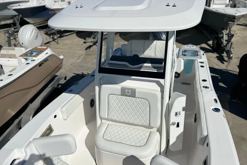 Slide: The Image of 2026 Sea Fox 228 Commander boat interior with white seating and console. - 14