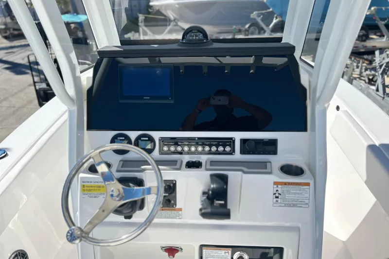 Slide: The Image of 2026 Sea Fox 228 Commander boat dashboard with steering wheel and control panel. - 16