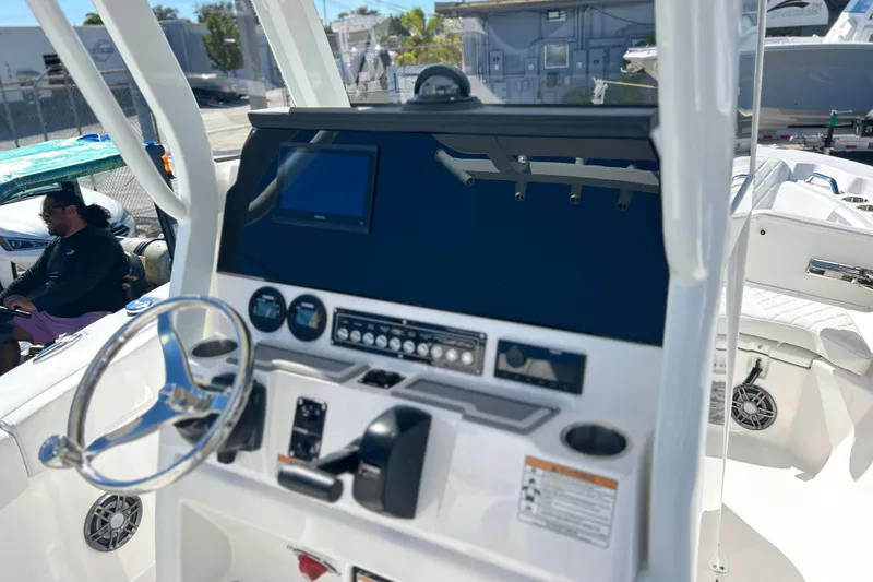 Slide: The Image of 2026 Sea Fox 228 Commander boat dashboard with steering wheel and control panel. - 17