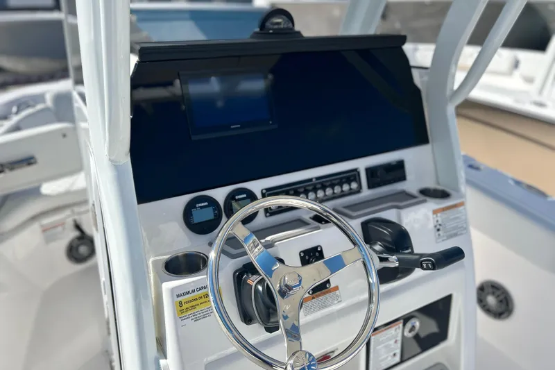 Slide: The Image of 2026 Sea Fox 228 Commander boat dashboard with steering wheel and controls. - 18
