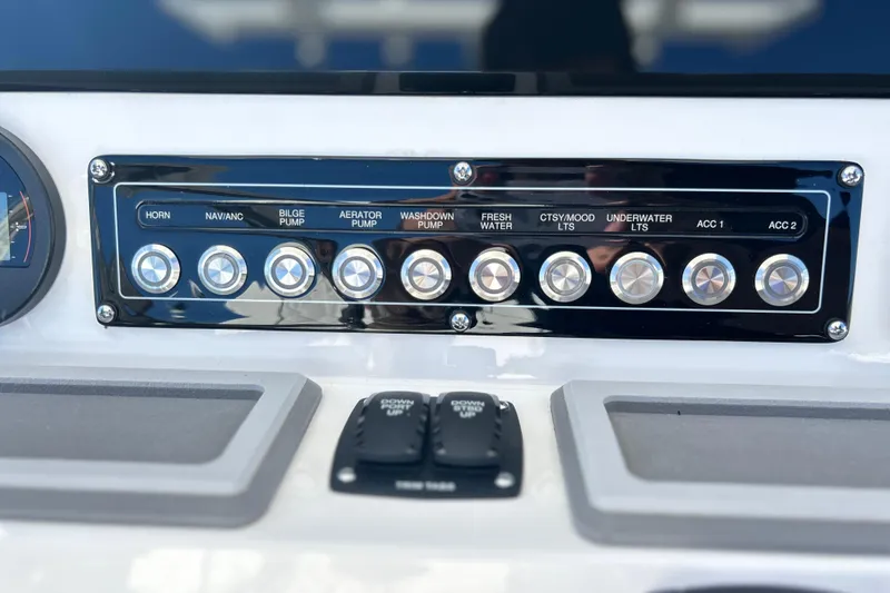 Slide: The Image of Control panel of 2026 Sea Fox 228 Commander boat with labeled switches. - 19