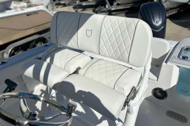 Slide: The Image of 2026 Sea Fox 228 Commander boat with white quilted seating and steering wheel. - 23