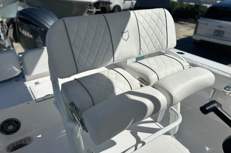 Slide: The Image of Luxury seating on 2026 Sea Fox 228 Commander boat, featuring quilted white upholstery. - 26