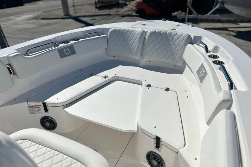 Slide: The Image of 2026 Sea Fox 228 Commander boat interior with white seating and storage compartments. - 3