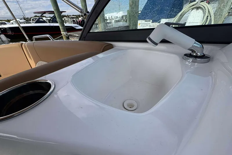 Slide: The Image of 2024 NauticStar 223 DC boat interior with sink and faucet detail. - 10