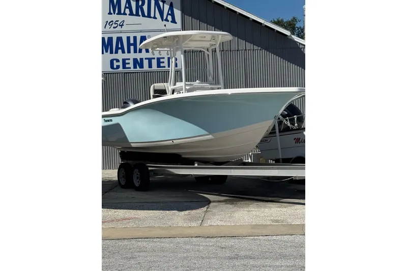 The Image of 2021 Tidewater 220 LXF boat on trailer at marina center. - 0