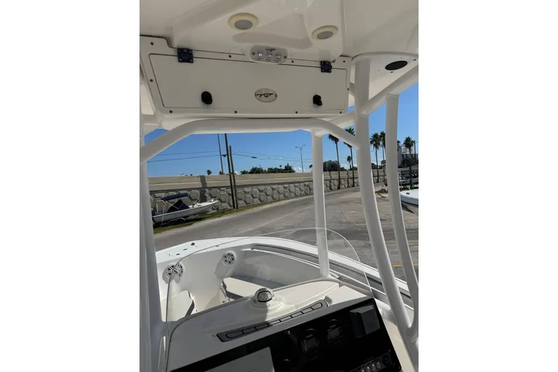 Slide: The Image of 2021 Tidewater 220 LXF boat interior with console and overhead storage. - 15