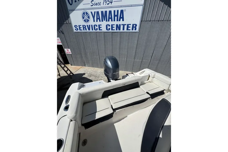Slide: The Image of 2021 Tidewater 220 LXF boat at Yamaha Service Center, featuring comfortable seating and outboard motor. - 19